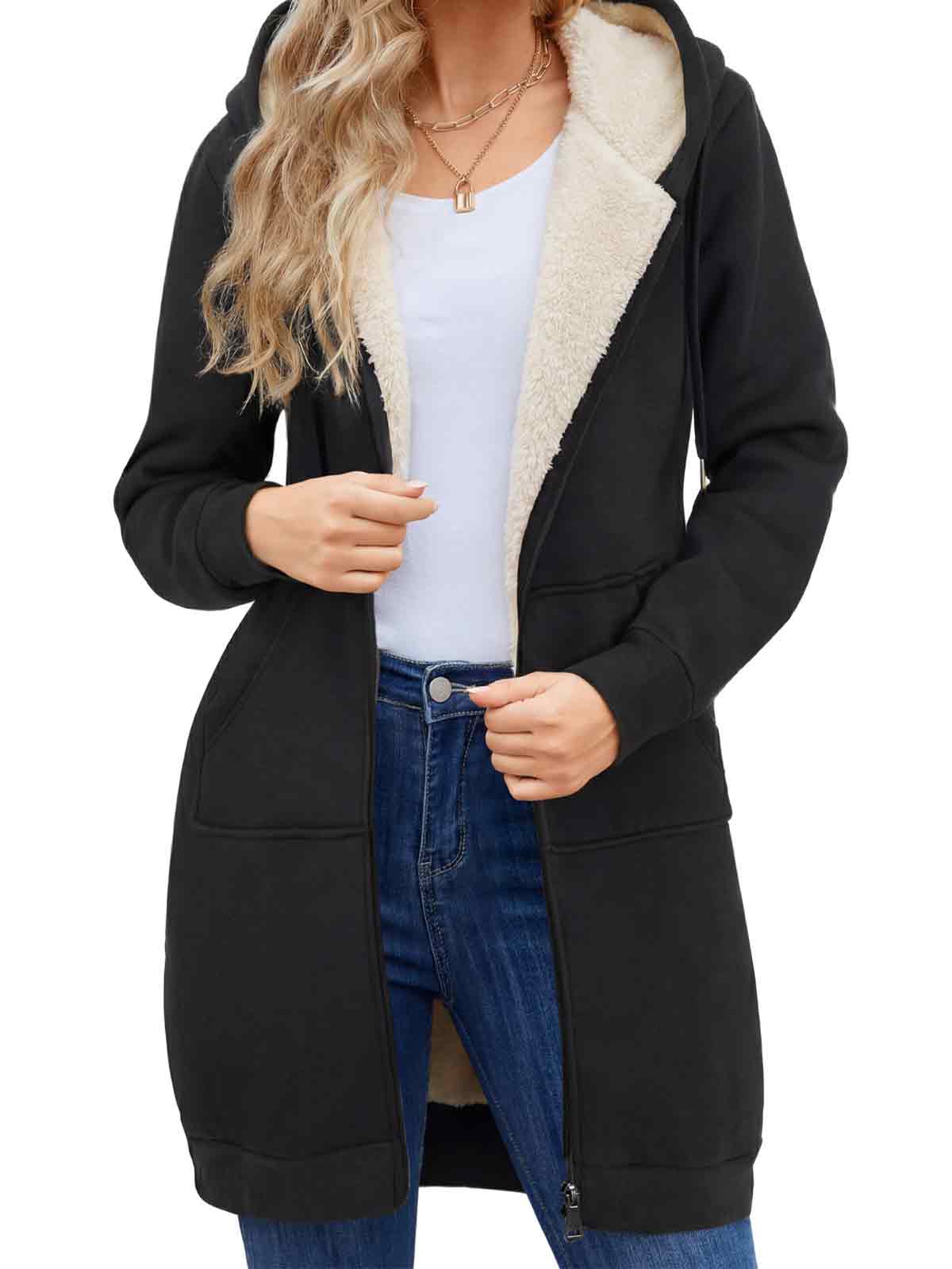 Black long coat with white sherpa lining worn by a person on a white background