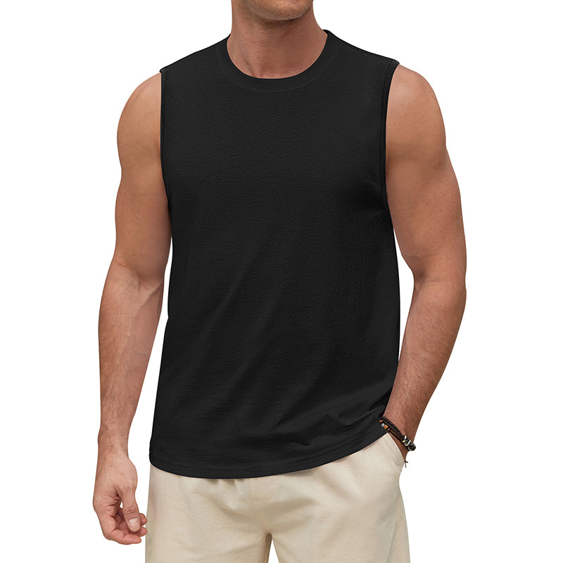 Man wearing a black sleeveless shirt on a white background
